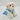 White plush dog toy with a blue outfit on a light gray background