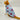 Cat wearing a light blue shirt with pink hearts on a white background