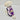 Dog wearing a purple and white outfit with cartoon character design on a gray background