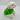 White fluffy dog wearing a green sweater on a light gray background