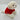 White plush dog toy wearing a red jacket on a light gray background