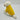 Dog wearing a yellow coat with white fur trim on a light gray background